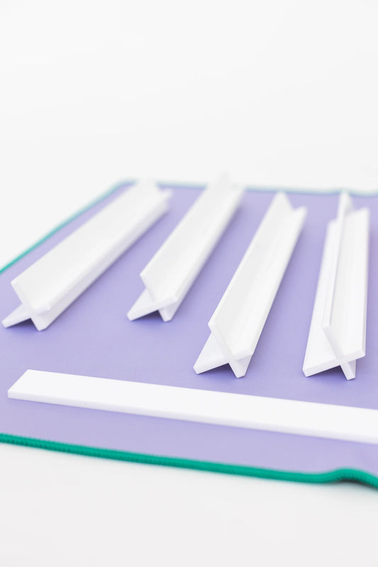 White Travel Racks Set of Four and One Pusher